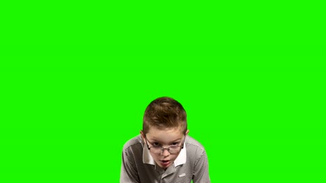 Little-boy-runs-at-green-background