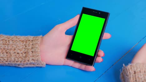 Woman-using-smartphone-with-green-screen