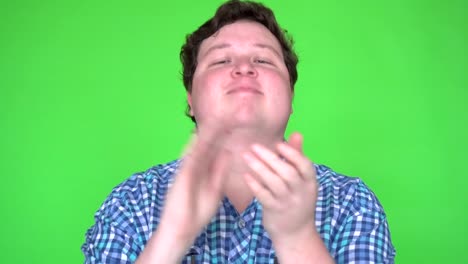 Young-man-clapping-on-chroma-key-green-screen-background