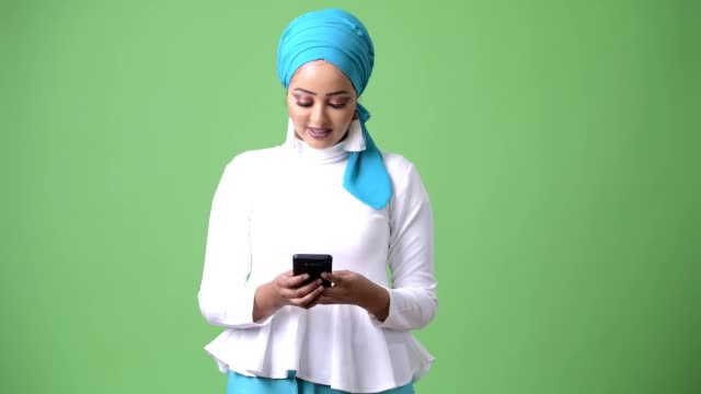 Young-beautiful-African-Muslim-woman-against-chroma-key-with-green-background