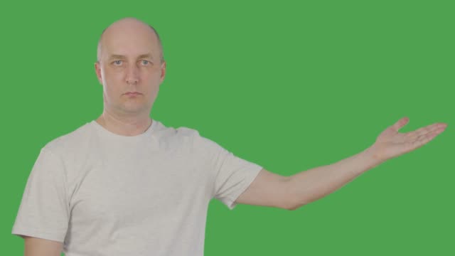 Confident-middle-aged-man-gesturing-and-presenting-something-on-keyed-green-screen.-Alpha-channel