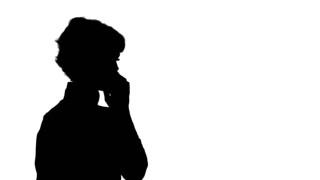 Silhouette-Happy-businesswoman-speaking-at-the-phone-track-matte