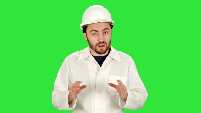 Construction-worker-on-building-site-talking-to-camera-on-a-Green-Screen,-Chroma-Key