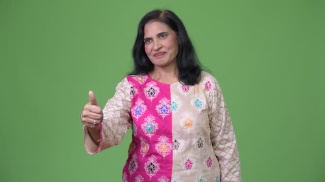 Mature-beautiful-Indian-woman-giving-thumbs-up
