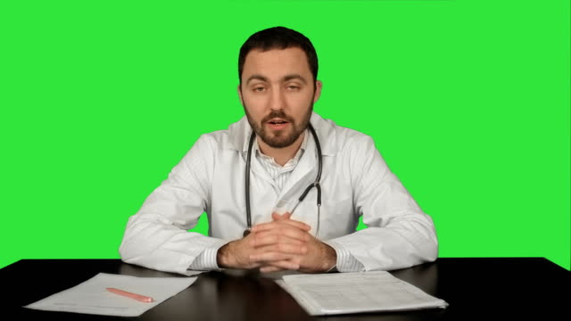 Cheerful-smiling-doctor-with-good-news-looking-at-camera-on-a-Green-Screen,-Chroma-Key