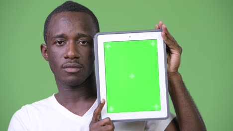 Young-African-man-showing-digital-tablet