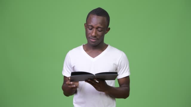 Young-African-man-reading-book-and-thinking