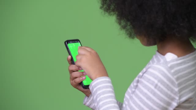 Young-cute-African-girl-with-Afro-hair-using-phone