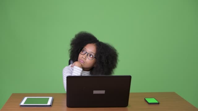 Young-cute-African-girl-with-Afro-hair-using-laptop