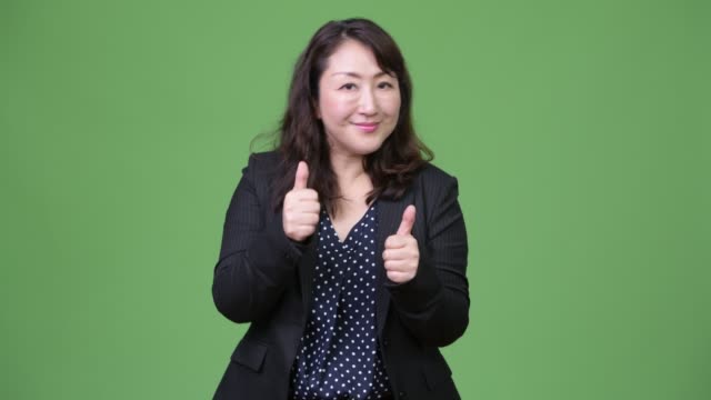 Mature-beautiful-Asian-businesswoman-giving-thumbs-up