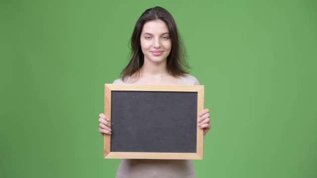 Young-happy-beautiful-woman-holding-blackboard