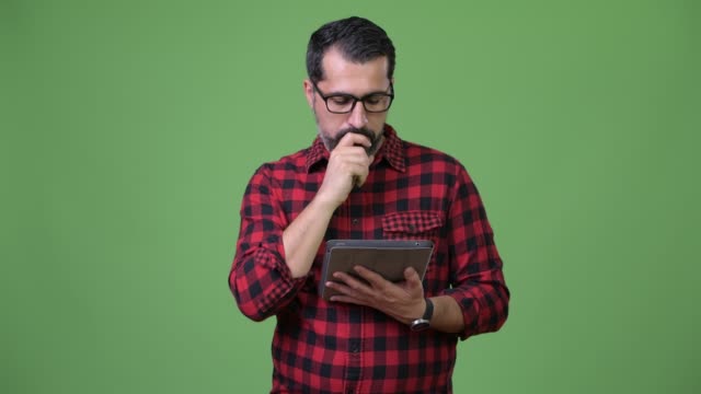 Handsome-Persian-bearded-man-using-digital-tablet