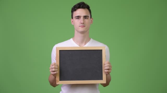 Young-happy-handsome-man-holding-blackboard
