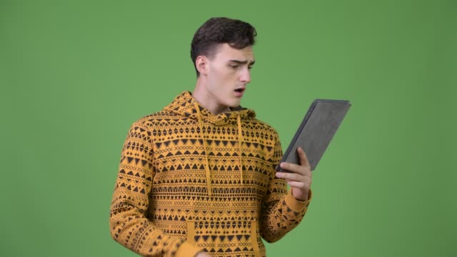 Young-handsome-man-using-digital-tablet-and-getting-bad-news