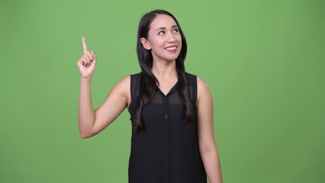 Young-beautiful-Asian-businesswoman-pointing-finger-up