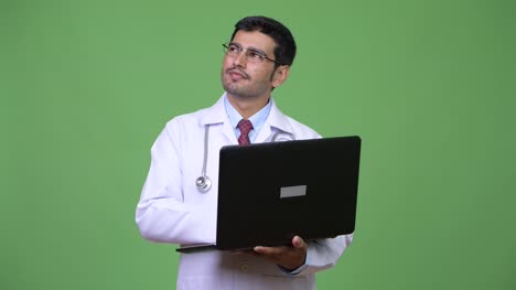 Young-handsome-Persian-man-doctor-using-laptop