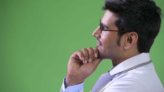 Profile-view-of-young-handsome-Persian-man-doctor-thinking