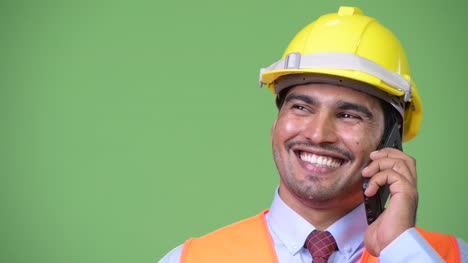 Young-handsome-Persian-man-construction-worker-talking-on-the-phone