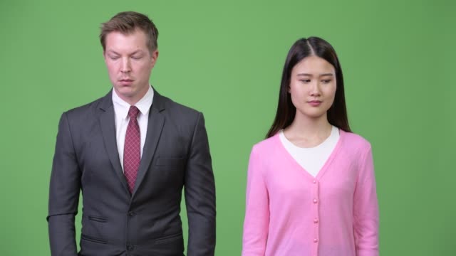Young-Asian-woman-and-young-businessman-thinking-together