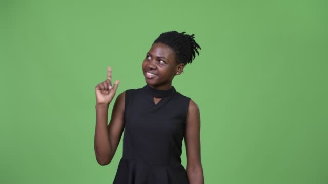 Young-beautiful-African-businesswoman-thinking-while-pointing-finger-up