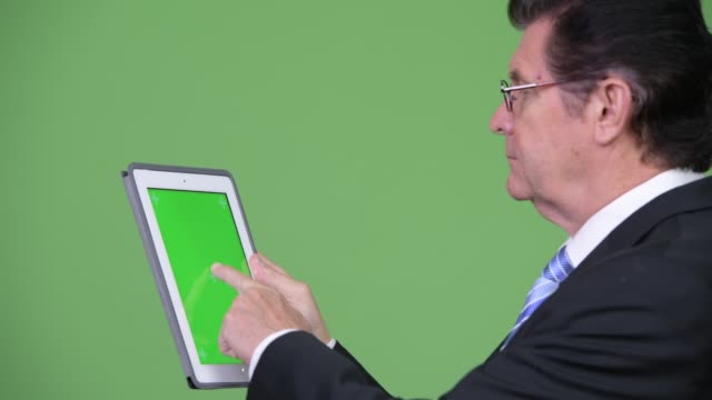 Senior-handsome-businessman-using-digital-tablet