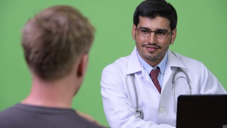 Young-Persian-man-doctor-consulting-young-man-patient