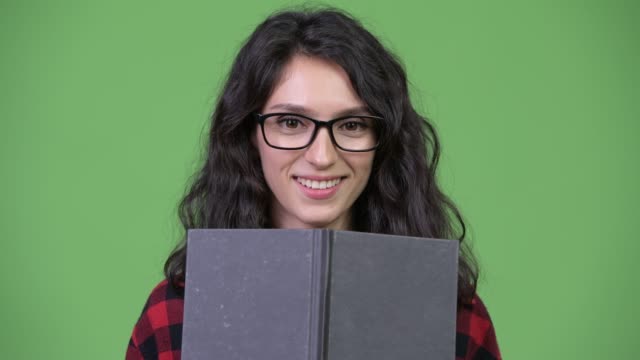 Young-beautiful-businesswoman-covering-face-with-book