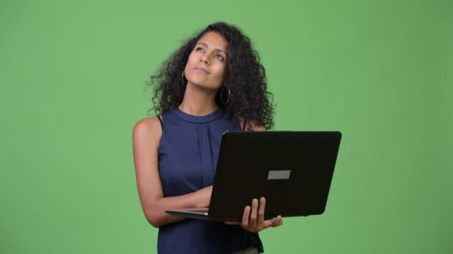 Young-beautiful-Hispanic-businesswoman-using-laptop