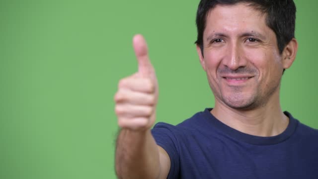 Close-up-of-happy-Hispanic-man-giving-thumbs-up