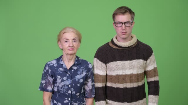 Angry-grandmother-and-grandson-giving-thumbs-down-together