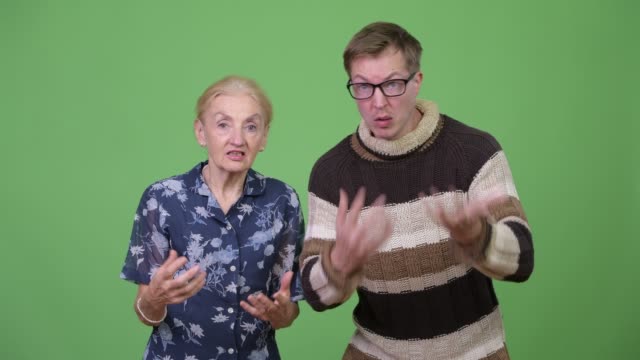 Angry-grandmother-and-grandson-talking-and-gesturing-in-rage-together