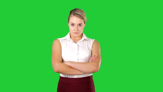 Smiling-business-woman-with-folded-hands-on-a-Green-Screen,-Chroma-Key