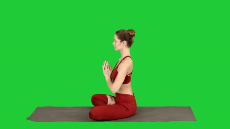 Young-sporty-attractive-woman-practicing-yoga,-doing-Lotus-pose-on-a-Green-Screen,-Chroma-Key