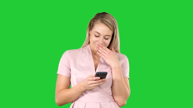 Blonde-girl-holding-mobile-phone-Young-woman,-cellphone-addiction,-online-dating-app,-communication,-new-technologies,-trendy-concepts-on-a-Green-Screen,-Chroma-Key