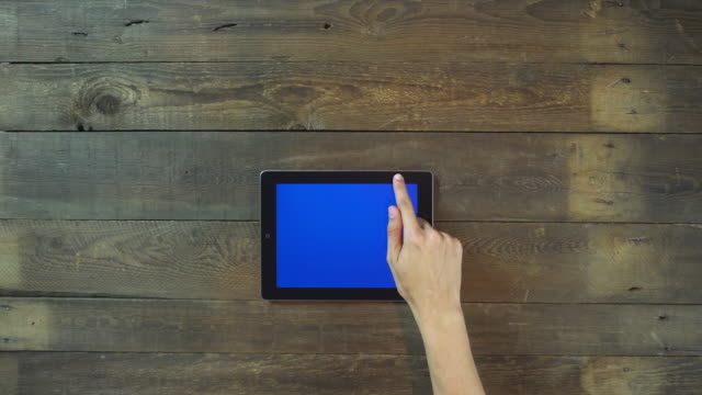 Seitenhiebe-auf-Hand-Digital-Tablette-mit-Bluescreen