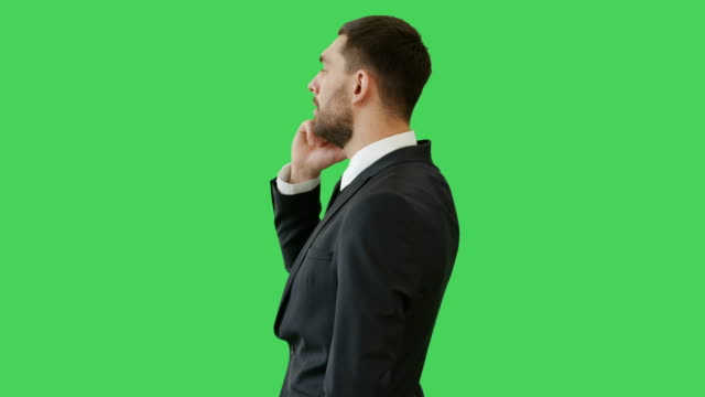 Medium-Shot-of-a-Handsome-Serious-Minded-Businessman-Talking-on-the-Phone.-His-Background-is--Green-Screen.