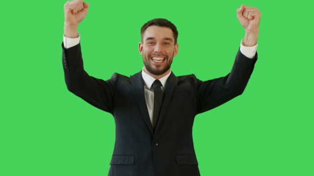 Medium-Shot-of-a-Handsome-Businessman-Making-Win-Gestures-and-Rejoycing.-Celebrating-His-Success.-Background-is-Green-Screen.