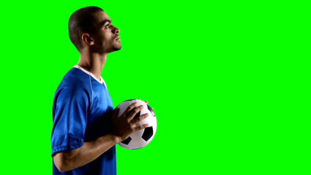 Profile-of-football-player-holding-a-football