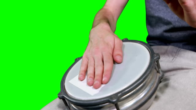 Mid-section-of-drummer-playing-drum