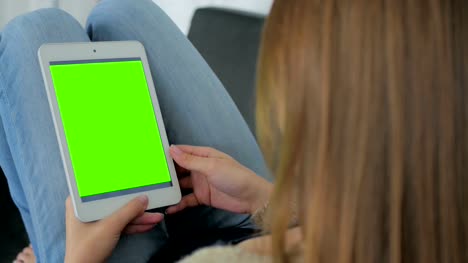 Woman-using-tablet-computer-with-green-screen