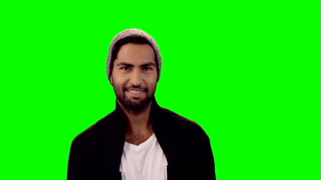 Smiling-man-standing-against-green-screen