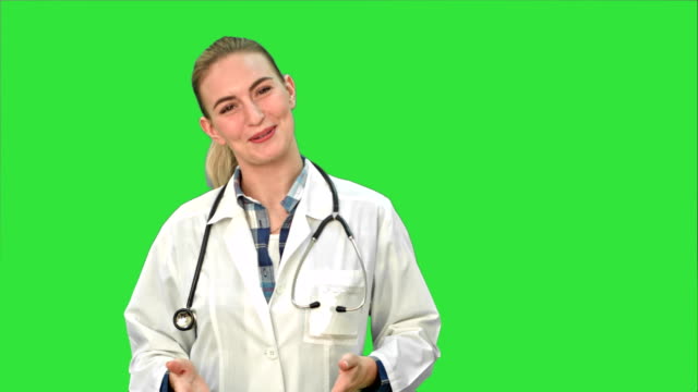 Smiling-beautiful-woman-in-lab-coat-talking-to-the-camera-on-a-Green-Screen,-Chroma-Key