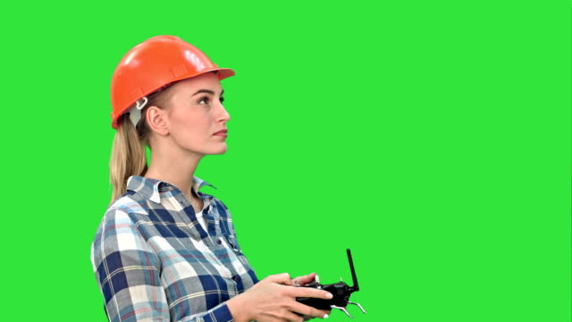 Female-engineer-operating-a-drone-analyzing-object-on-a-Green-Screen,-Chroma-Key