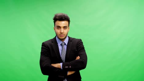 Angry-Businessman-Stand-Folded-Hands-Over-Chroma-Key-Green-Screen-Portrait-Of-Young-Mix-Race-Business-Man