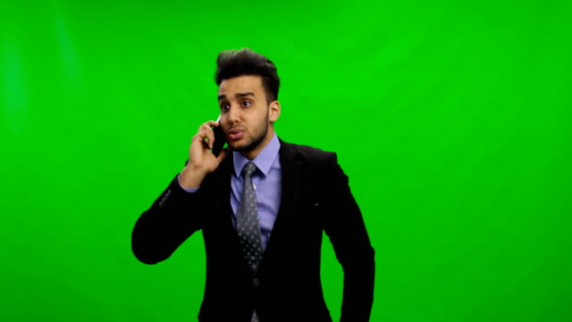 Sad-Young-Businessman-Calling-On-Phone-Over-Chroma-Key-Green-Screen-Latin-Business-Man-Solving-Problems-Serious-Crisis