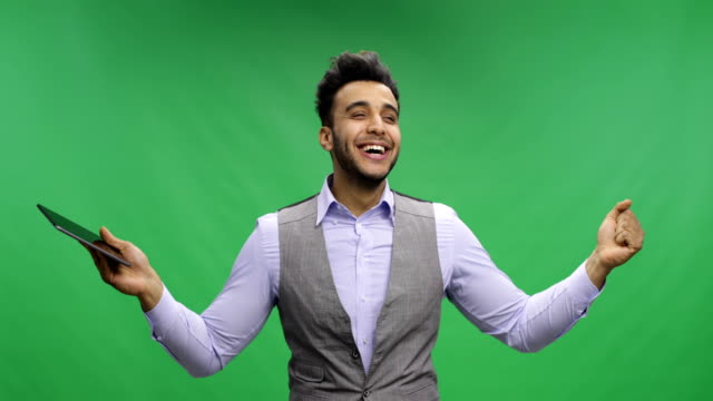 Cheerful-Businessman-Hold-Tablet-Computer-Over-Chroma-Key-Green-Screen-Happy-Smiling-Young-Latin-Business-Man