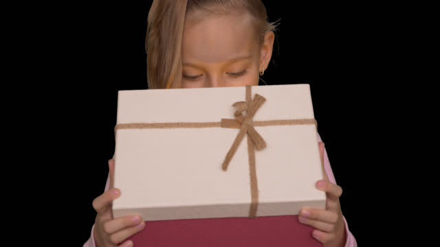 Young-caucasian-girl-open-gift-box-front-view.-Holiday-eve.-Alpha-channel-chroma-key-transparent-background.-Happy-young-girl-opening-gift-box.-Shining-light-from-gift-box.