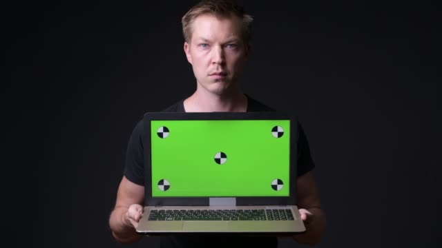 Man-Holding-Laptop-With-Chroma-Key-Green-Screen