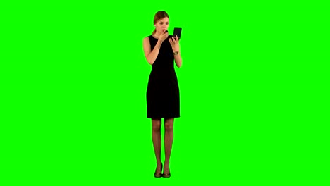 Young-adult-woman-applying-lipstick-herself-on-a-Green-Screen
