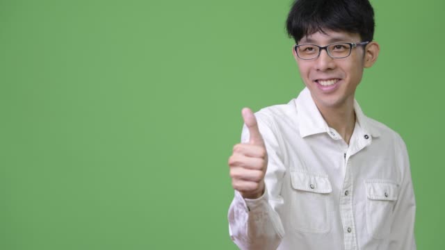 Young-Asian-businessman-giving-thumbs-up